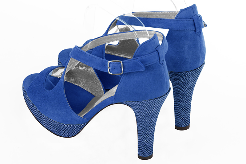 Electric blue women's closed back sandals, with crossed straps. Round toe. Very high slim heel with a platform at the front. Rear view - Florence KOOIJMAN